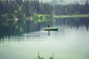 a man doing kayak fishing on the lake