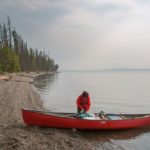a person on red kayak boat