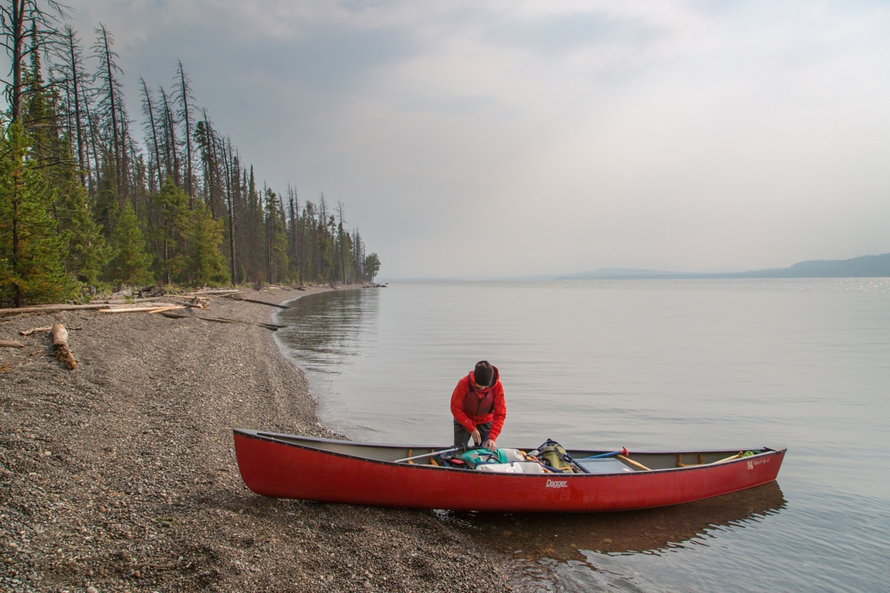 a person on red kayak boat